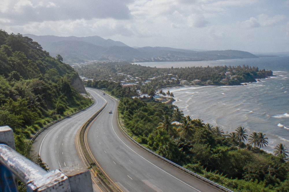 Toll highway curving through green hills toward the Samaná peninsula