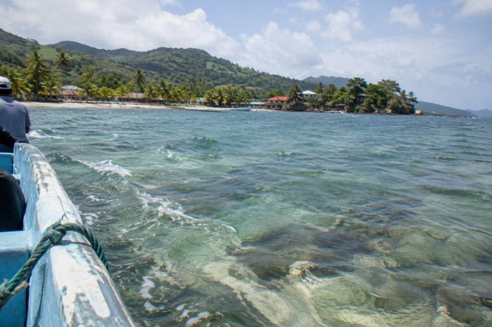 Shallow turquoise water over a sandbank under a clear sky in Samaná Bay