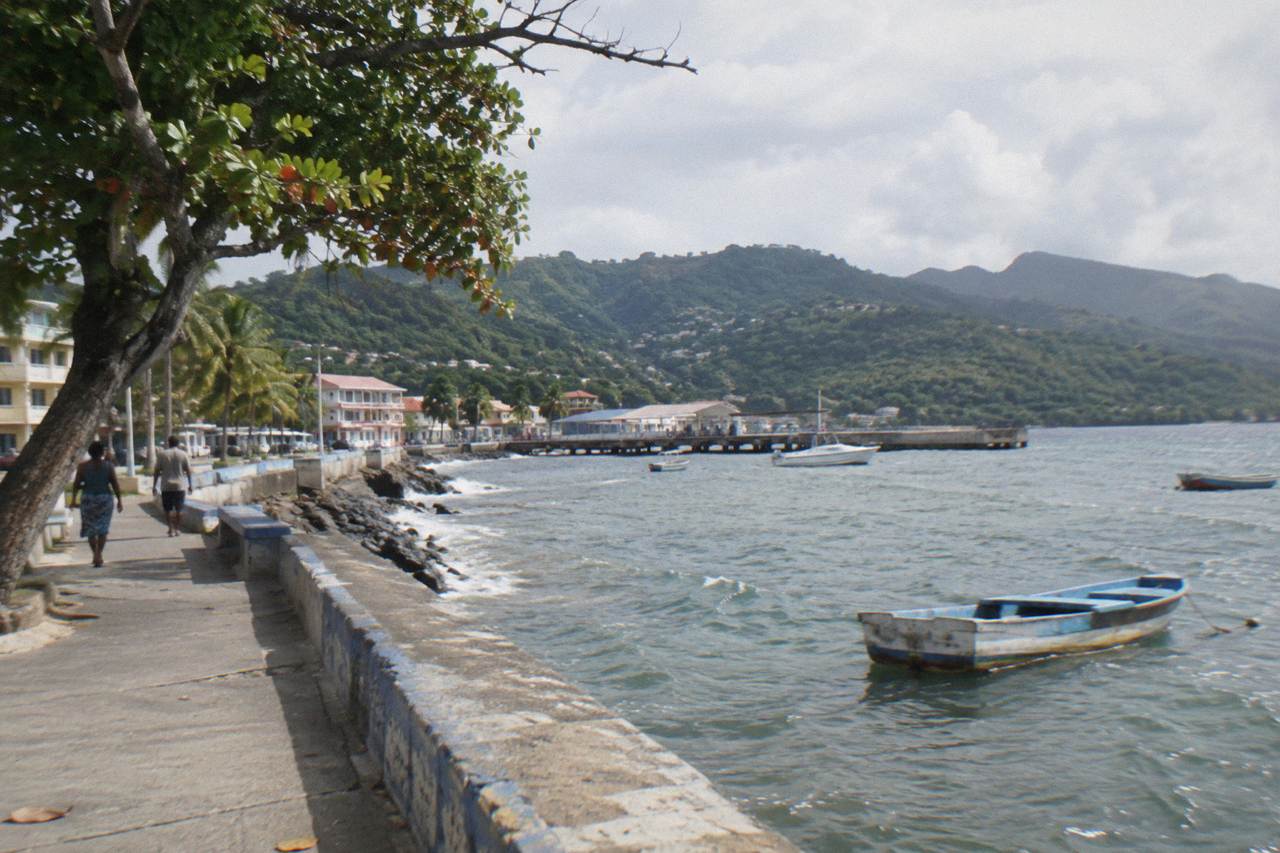 Open coastal highway curving toward green hills on the Samaná peninsula