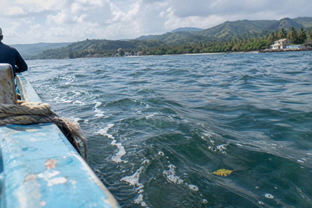 Open water of Samana Bay with small wind ripples under a morning sky