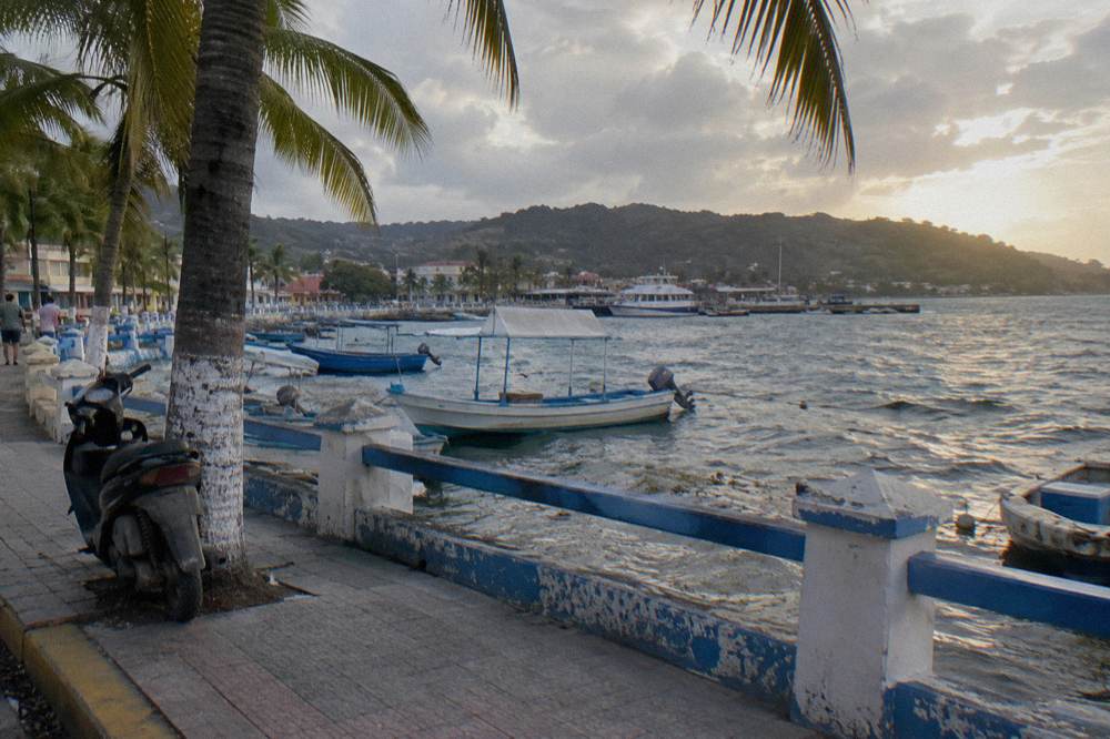 Waterfront promenade and boats moored along Avenida La Marina in Samana town