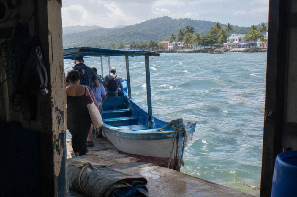 Wooden whale watching boat at a dock in Samana town with passengers boarding