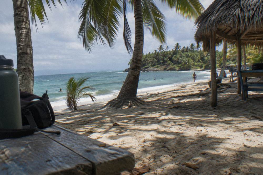 A buffet lunch set out on a shaded beach table on Cayo Levantado